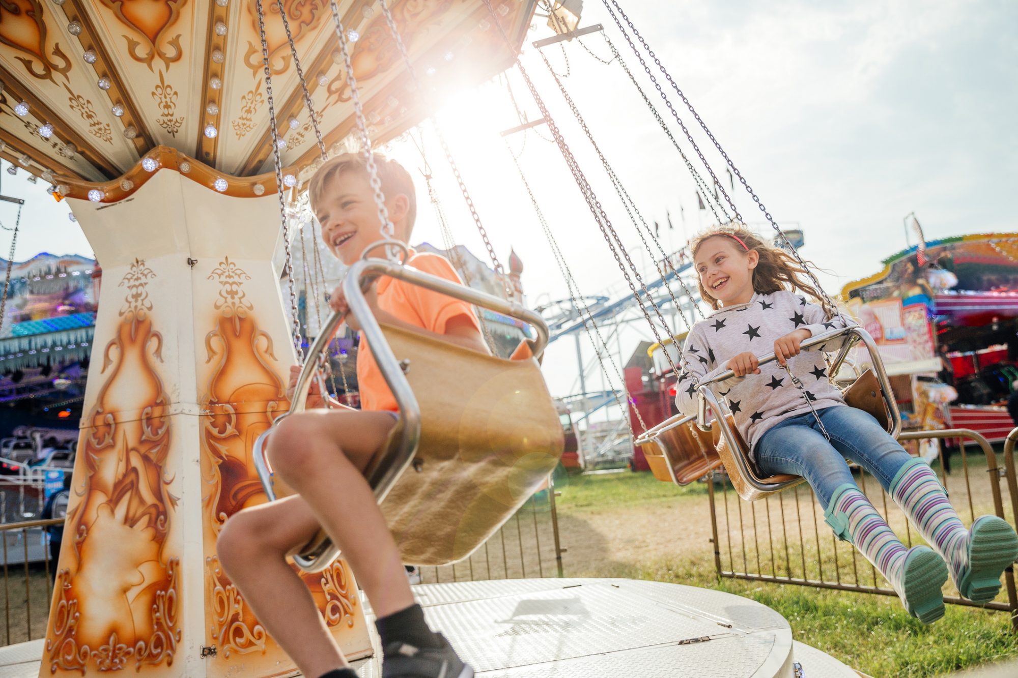 An image of children on a swing ride at an theme park.