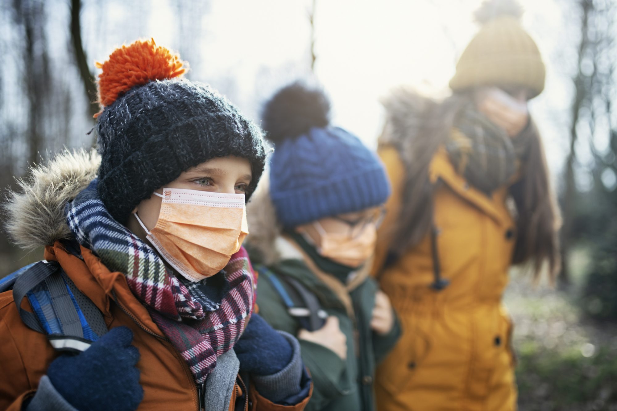 A group of kids wearing masks.